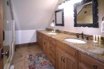 Master bathroom with dual vanities and a walk-in shower